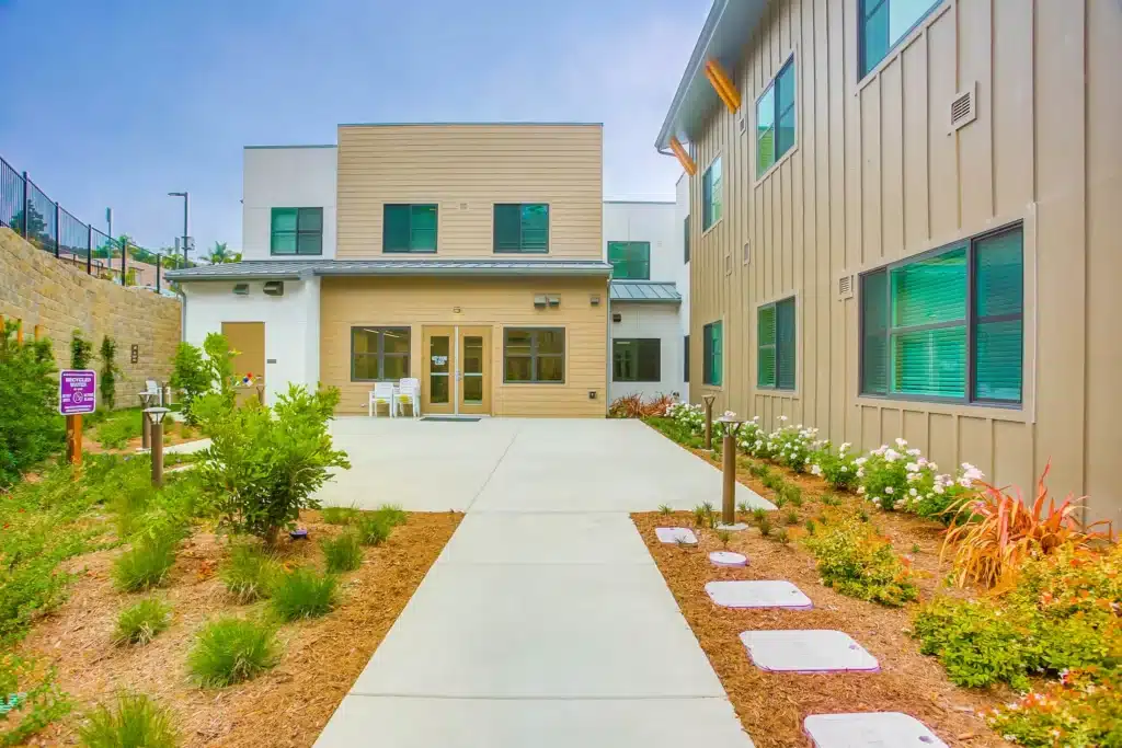 a building with a patio and a lawn