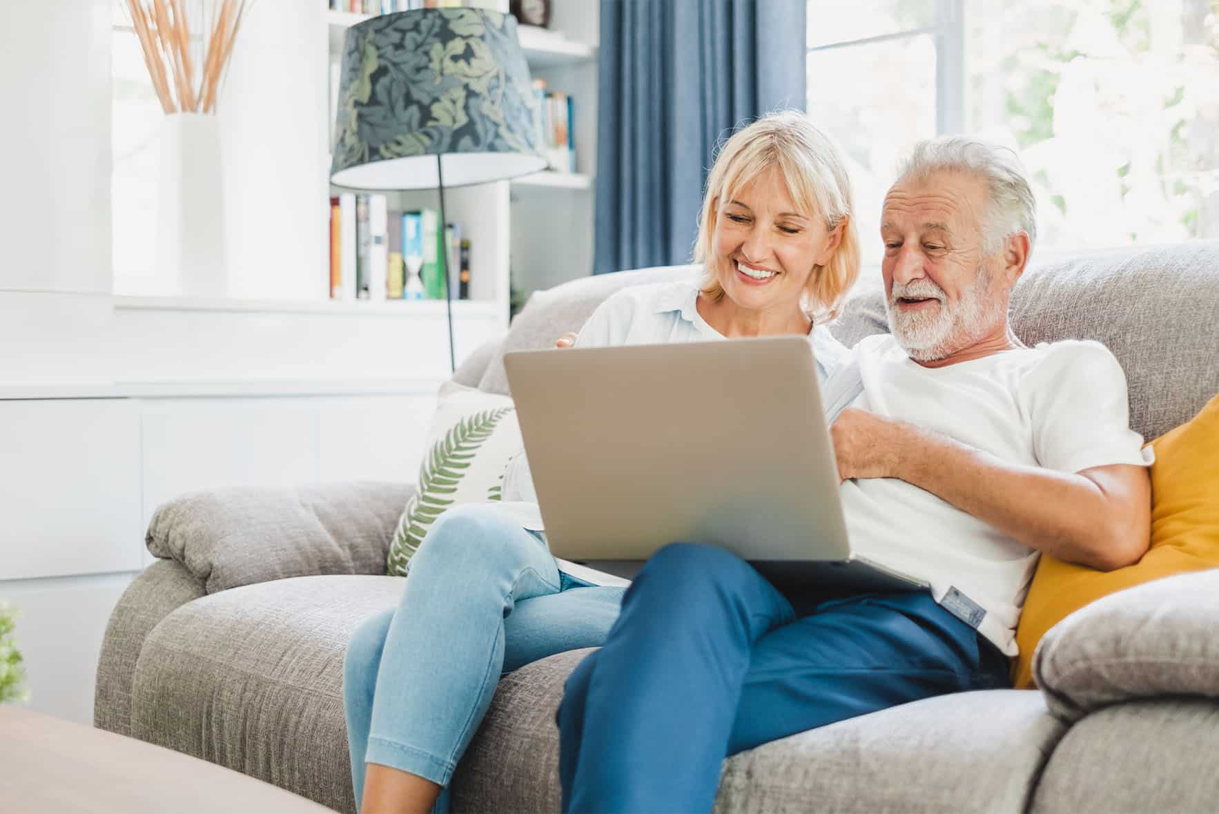 Senior's holding a laptop