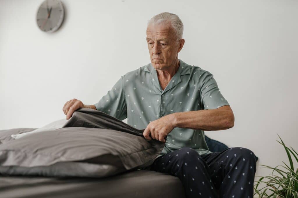 Senior sitting on a bed