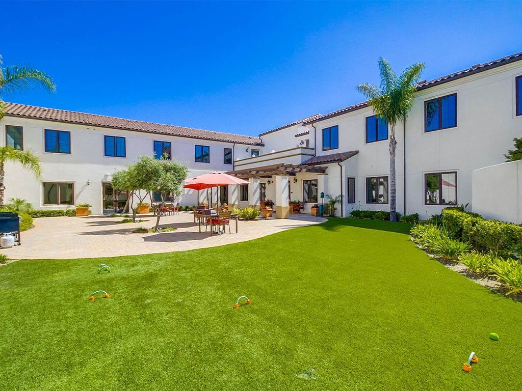 a building with a patio and a lawn