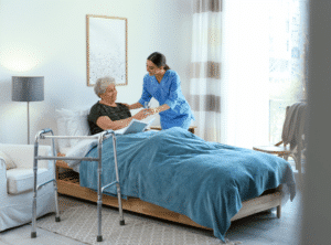 A nurse assists an elderly woman in bed, providing care and support in a compassionate healthcare setting.